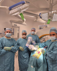 Specialist surgical team using robotic technology for safer spine procedures. Spine surgeons performing robotic-assisted spinal surgery