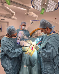 Robotic spine surgery led by Mr. Bhaskar Thakur in a modern operating theatre. Spine surgeon performing robotic-assisted surgery in operating room