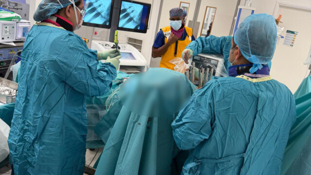 Spinal fixation surgery in operating theatre with pedicle screw placement in London Spinal fixation surgery in operating theatre with pedicle screw placement in London