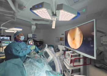 Spine surgeon performing minimally invasive endoscopic spine surgery using advanced instruments